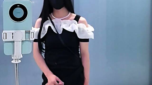 Chinese t-model in black cock-squeezing microskirt finishes off at the door of public rest room