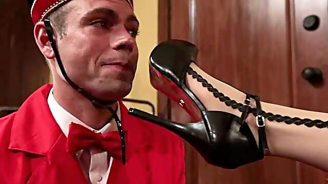 Hotel Guest Maitresse Madeline Dominates the Bellboy in Foot Fetish Video