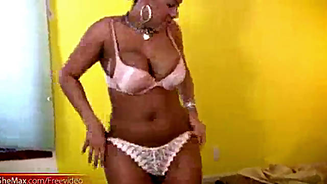 Black transsexual with massive milk cans jacks off on the bed