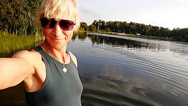 Swimming in the lake in sport wear at sunset.. Wet leggings and t-shirt...