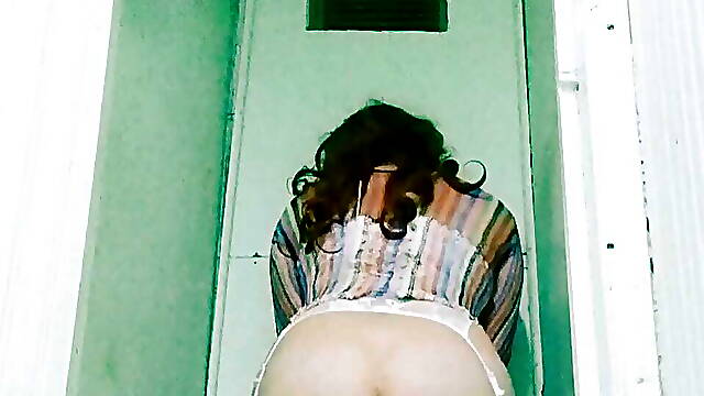 Female boy playing with dildo in public toilet