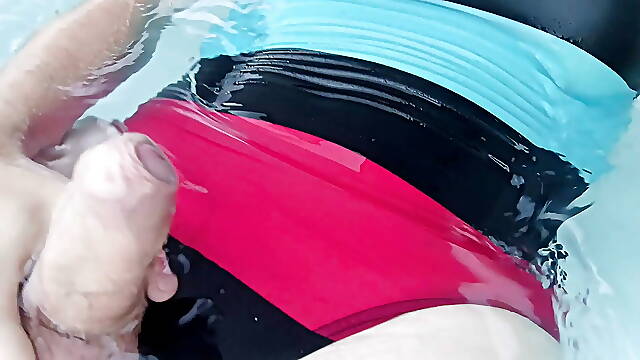 Tranny wearing sexy one piece swimsuit and swimming