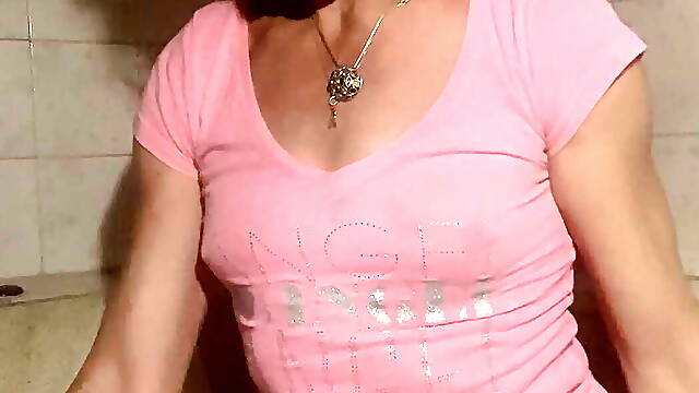 Soaking wet in bathroom in pink t-shirt, denim skirt and socks
