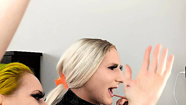 Crossdresser and Woman Putting on Lipliner and Lipstick