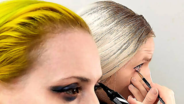 Crossdresser and Woman Putting on Eyeliner